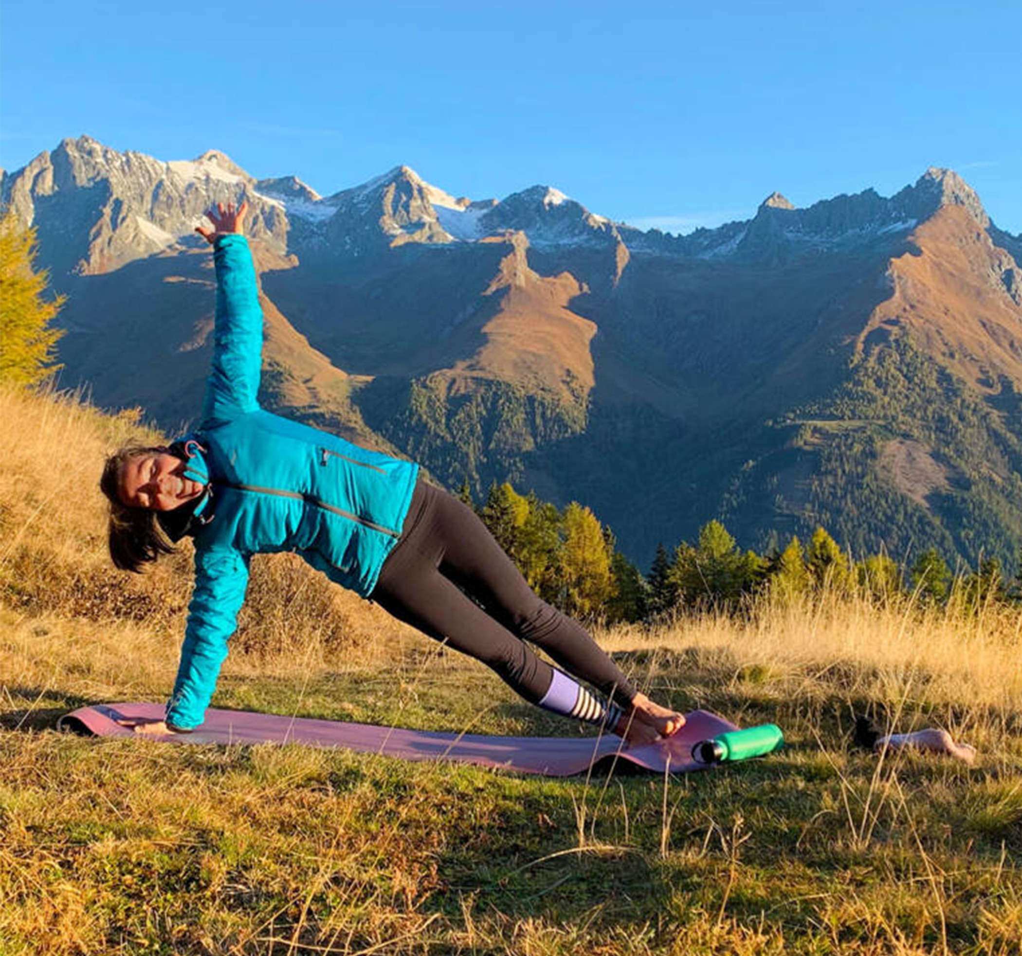 Woman doing yoga at sunrise in the mountains - Hotel Ortnerhof
